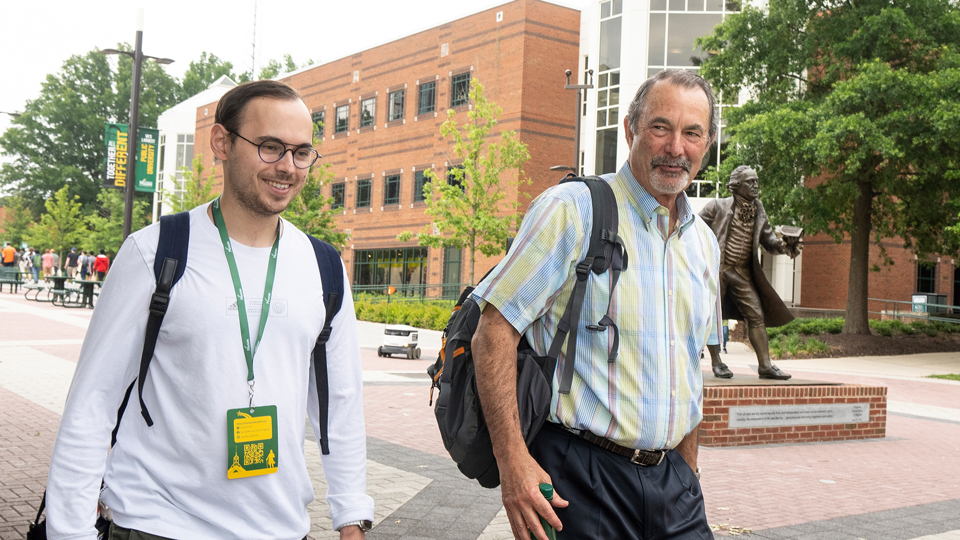 Professor of sports management in SRTM, Craig Esherick walks with a new sports management student during orientation. Esherick helps create opportunities for SRTM students through assistantships and practicum experiences.