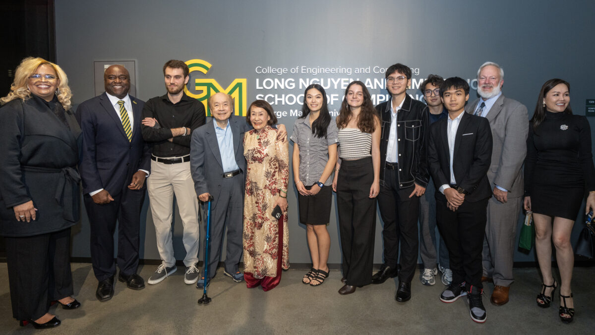 Long Nguyen and Kimmy Duong with a group of students and staff in front of a sign that reads "College of Engineering and Computing, Long Nguyen and Kimmy Duong School of Computing, George Mason University"